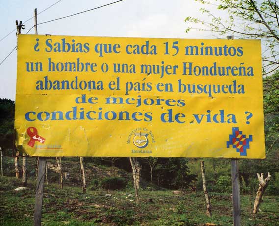 Road sign. "Did you know that every 15 minutes a Honduran man or woman leaves the country in search of better living conditions?" I can't really blame them.